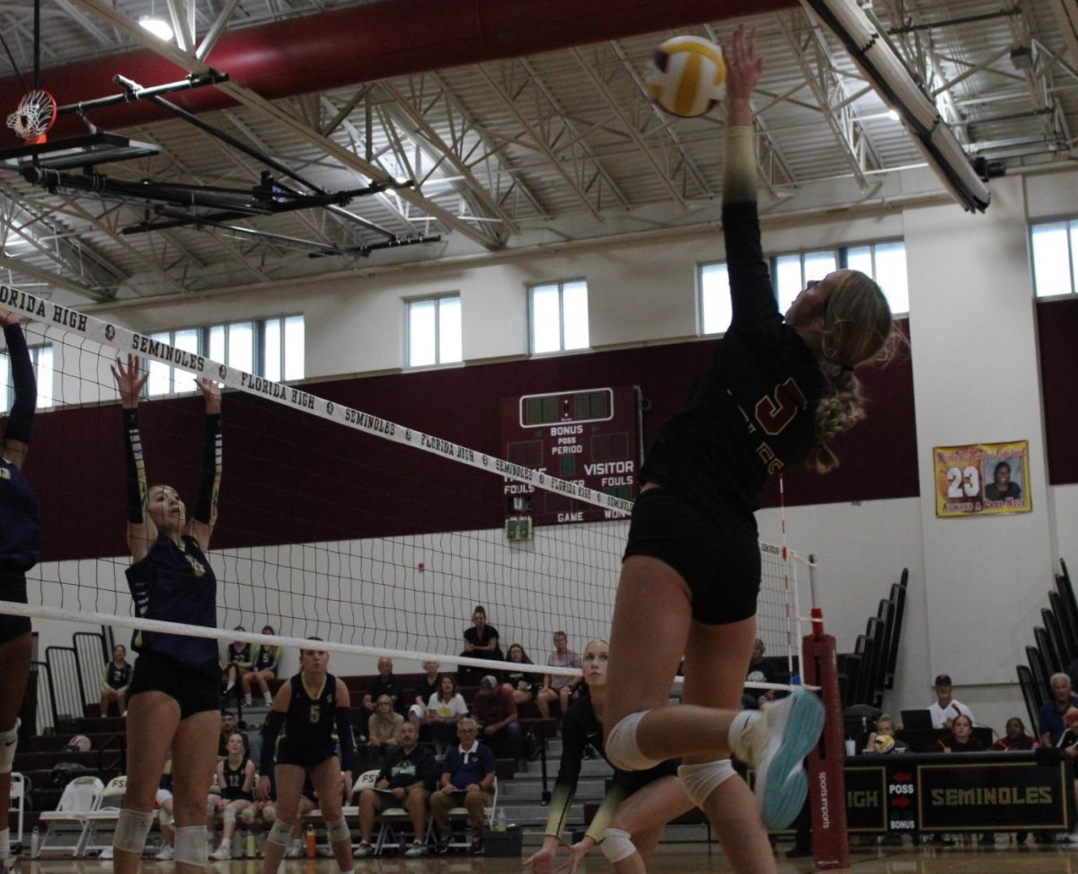 Junior Riley Maynard goes for the ball during a match. As a right side hitter, she has developed a relationship with her setter which has given them an advantage in matches. 

Photo courtsey of The Renegade.