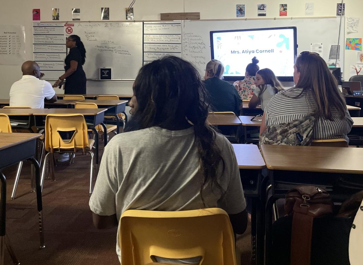 Parents listen as English teacher Atiya Cornell discusses policies and curriculum in her English 1 class.