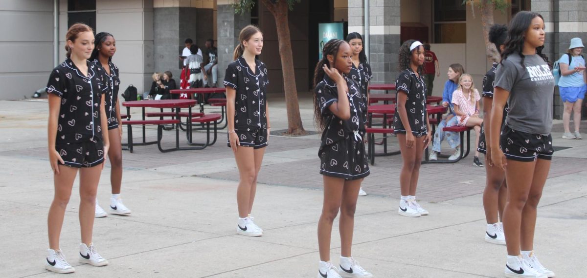 Dance team members wait to start their routine.