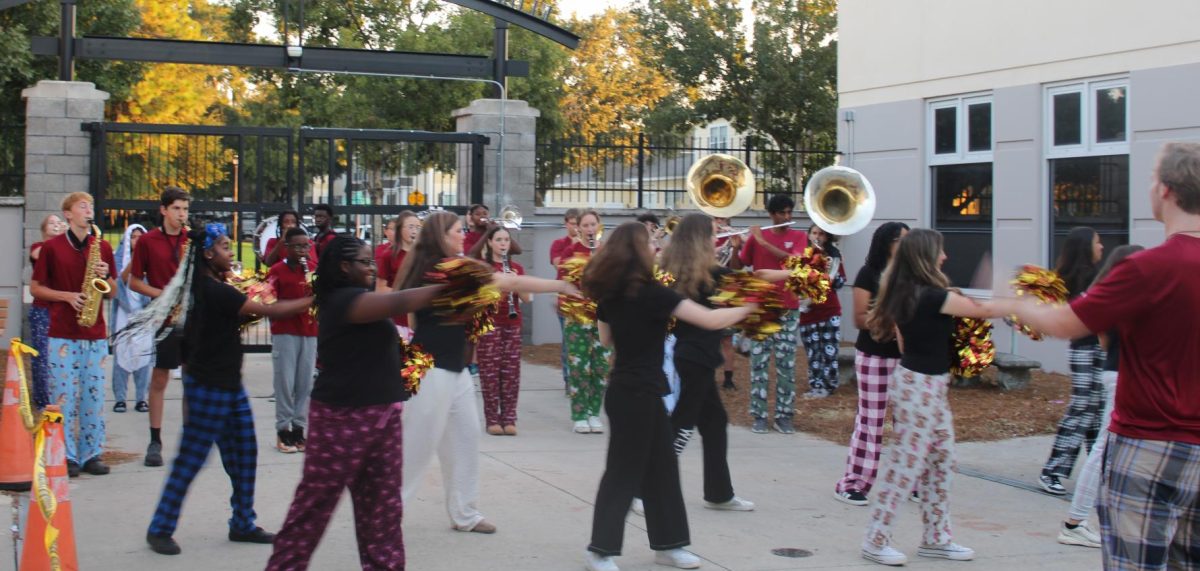 The Marching Braves lead the spirit of the pep rally, energizing the crowd early Monday morning.