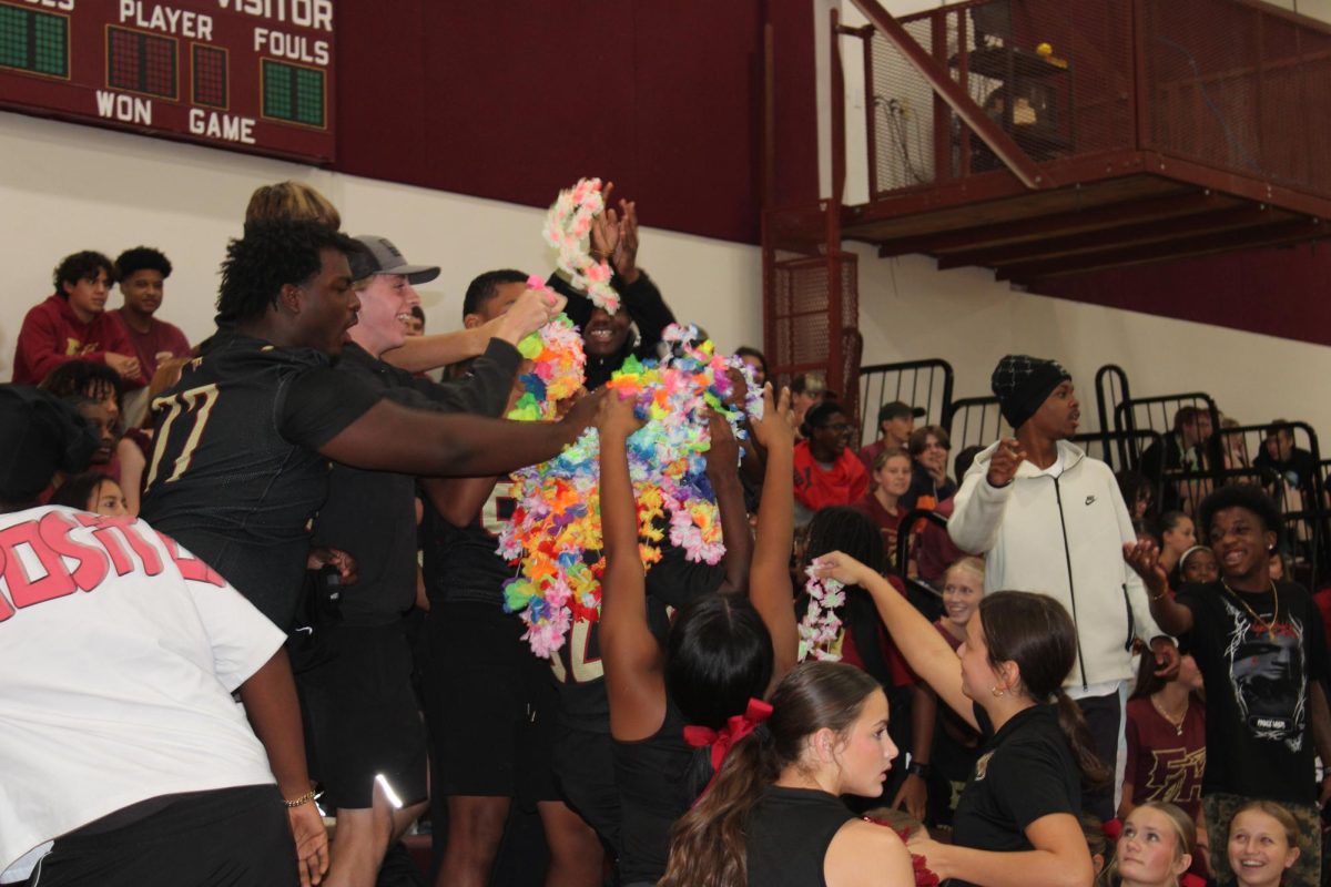 Sophomores toss their leis to Barack Sneed so he can participate in the final Battle of the Leis.