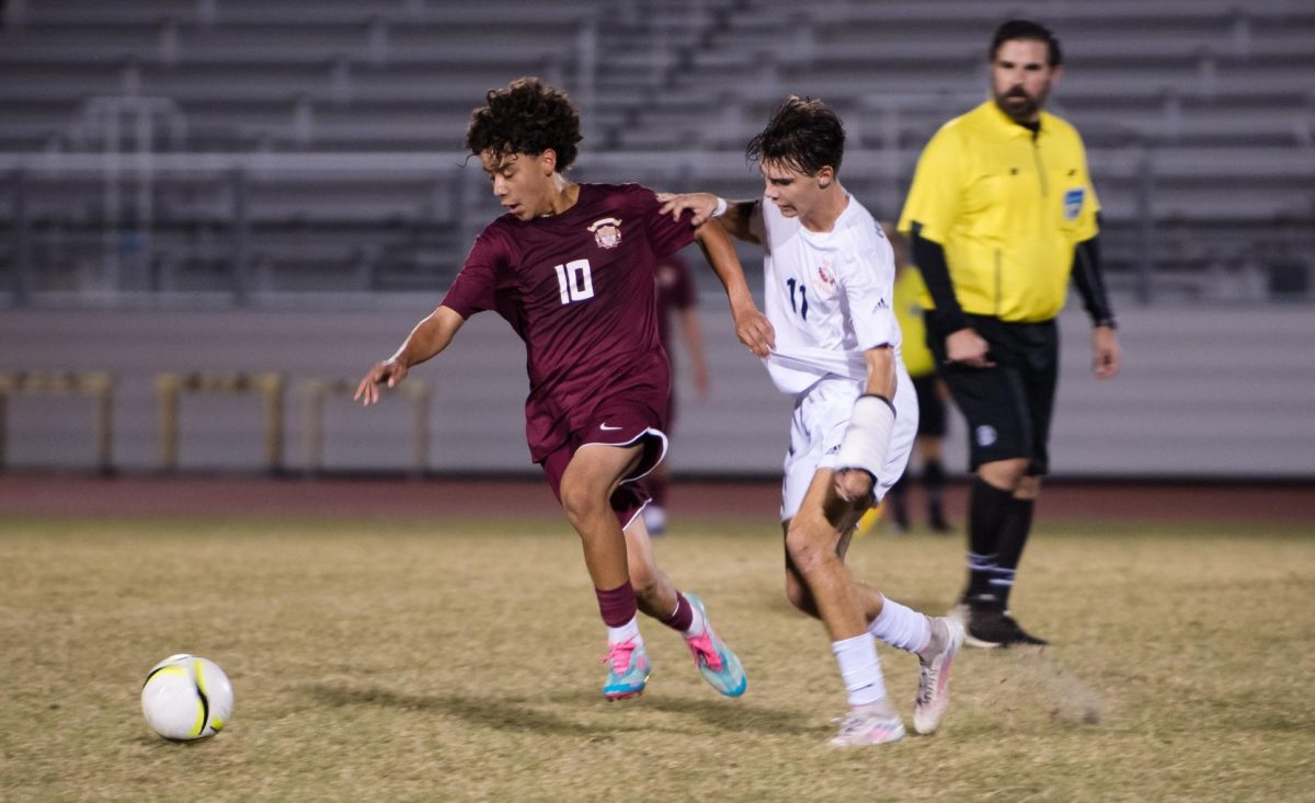 Freshman Valentino Gomez goes after the ball in a varsity soccer match. Gomez' skills on the field have earned him national recognition.
Photo courtesy of Valentino Gomez.