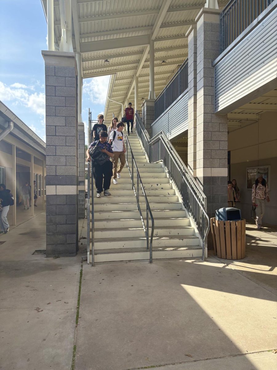 Students move between classes using the main stairwell during a class change. Busy transition periods often reveal the unspoken routines that shape daily campus movement.