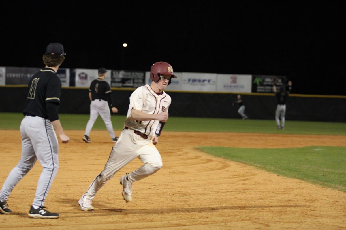 Senior Langston Chason rounds third and heads for home.
Photo courtesy of The Renegade.